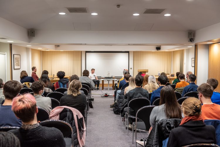 2 LGBTQ activists talking to the audience at Teddy Hall