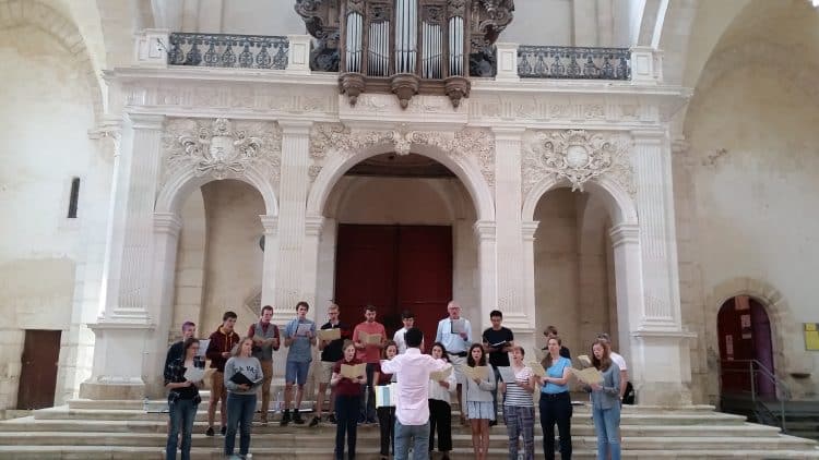 The Choir rehearsing in Pontigny Abbey, conducted by Organ Scholar Viraj