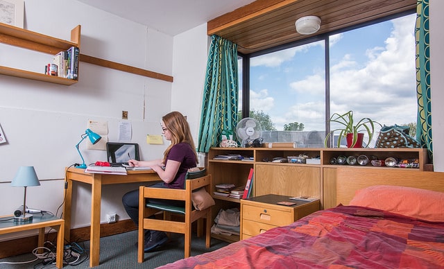 An undergraduate in her room in the Kelly building