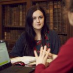 A student and tutor in the College's Old Library