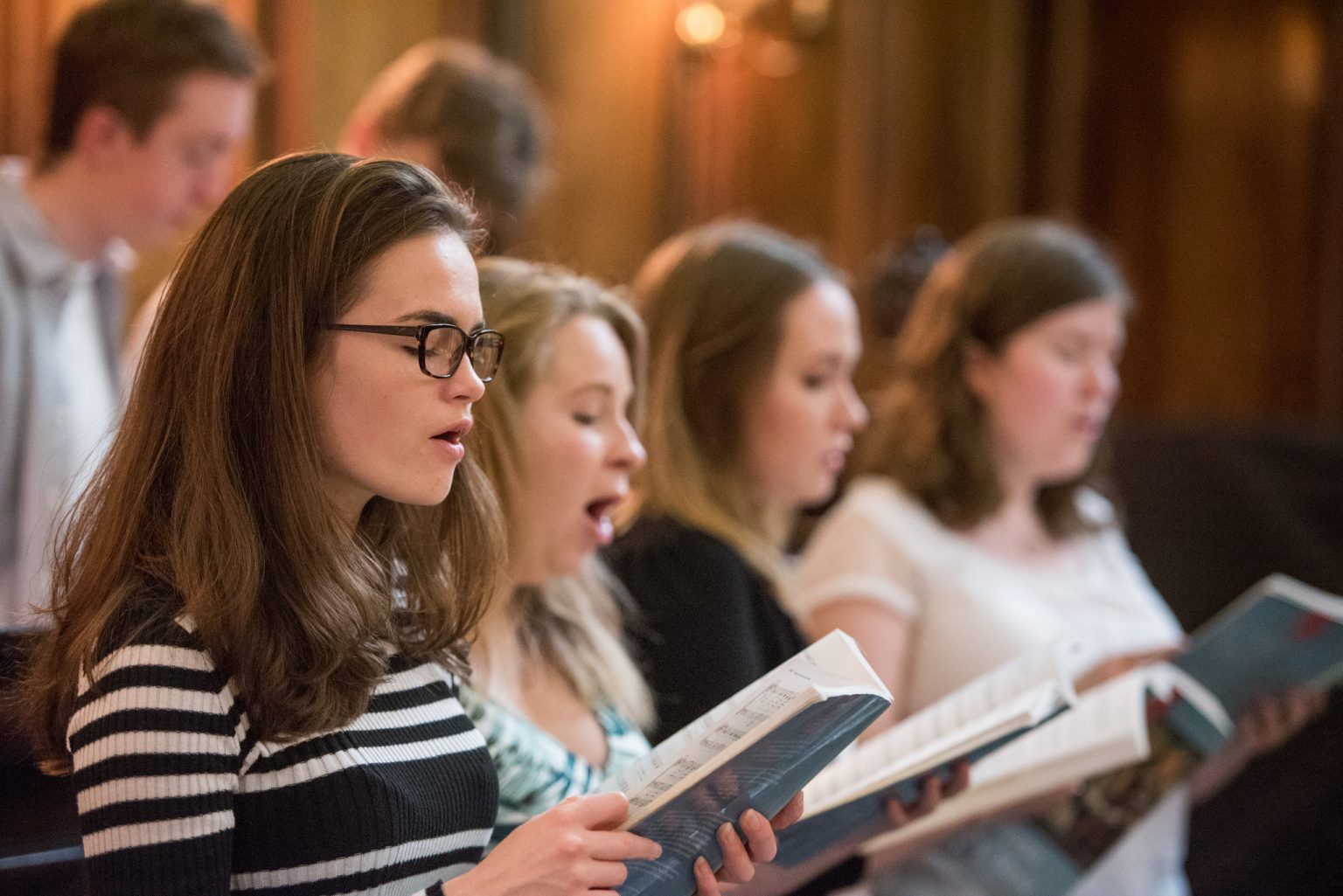 Students in the choir singing in the chapel
