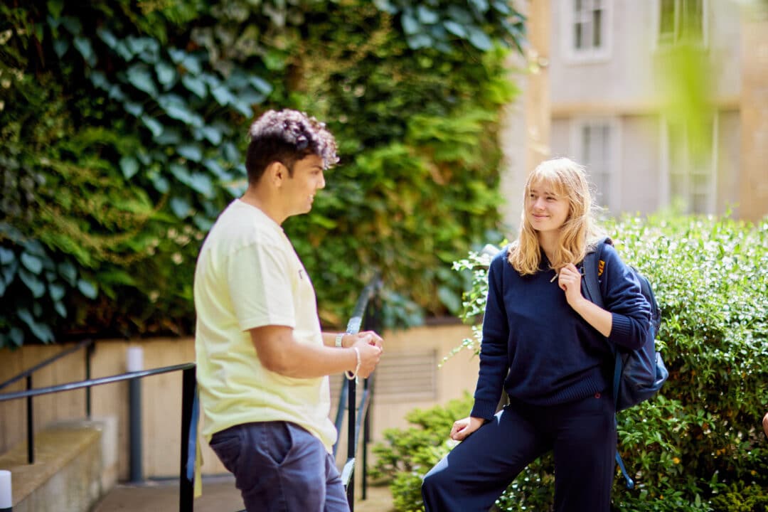 A group of St Edmund Hall students chatting in front of the living wall A group of St Edmund Hall students chatting in front of the living wall