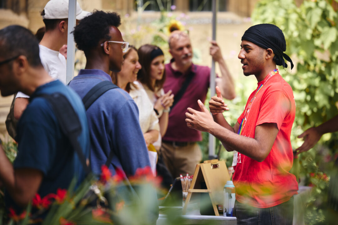 An Open Day student helper talking to guests on an Open Day