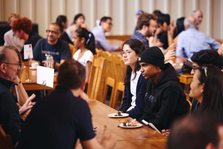 prospective students chatting to St Edmund Hall tutors in the College's Wolfson Hall during an Open Day