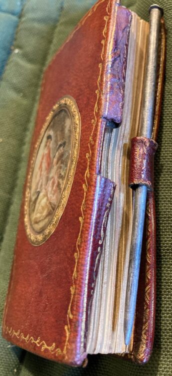 Binding and title page of 'Le Secrétaire des Dames' held in the Bibliothèque de l'Arsenal with a metal stylus that, with three leather loops, acts as a closure for the volume