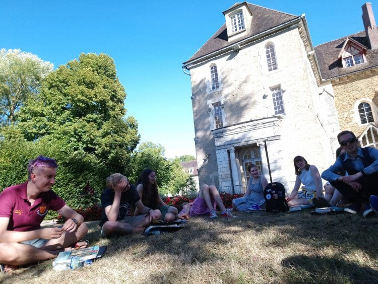 The choir taking some time out to relax in the sunshine during their tour to Pontigny and Paris