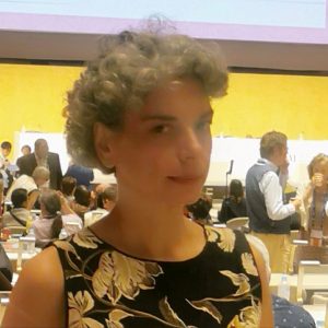Gina Koutsika Gina Koutsika at a busy event, three quarters profile