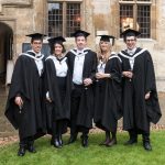 A group of graduates in the Front Quad at Teddy Hall