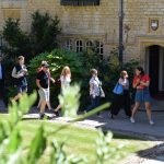 A student leads a tour group through the Front Quad