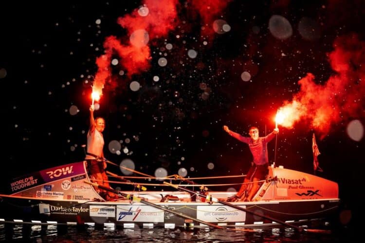 Jim and Ian on boat celebrating with red flares