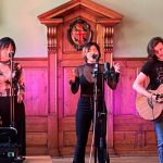 Teddy Hall students singing on stage in the Old Dining Hall, June 2021