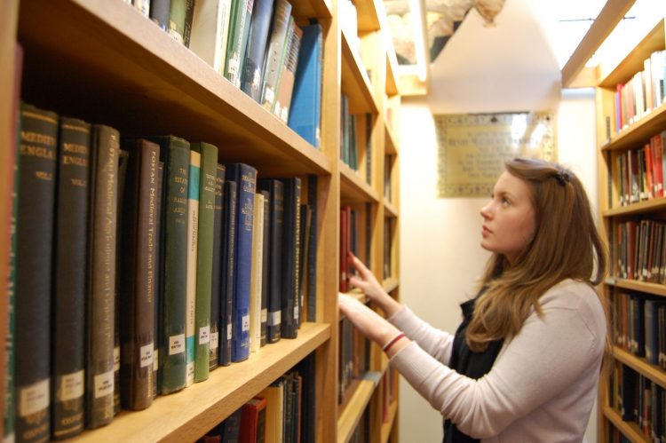 Student searching for book in St Edmund Hall Library