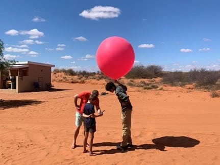 Second year undergraduate, Eoin Ware, gets some help with the weather balloon release
