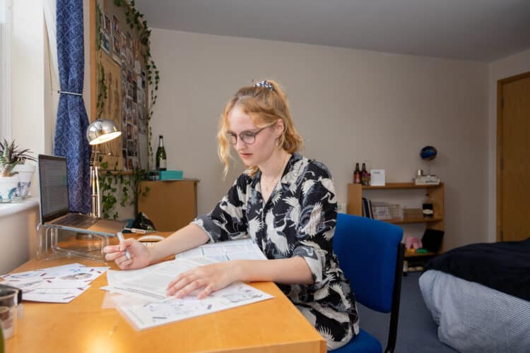 Student in atypical William R. Miller bedroom