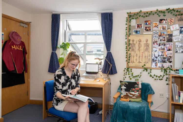 Student in atypical William R. Miller bedroom