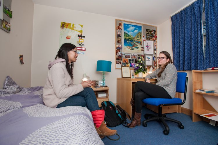 Two students in a room in the William R Miller Building