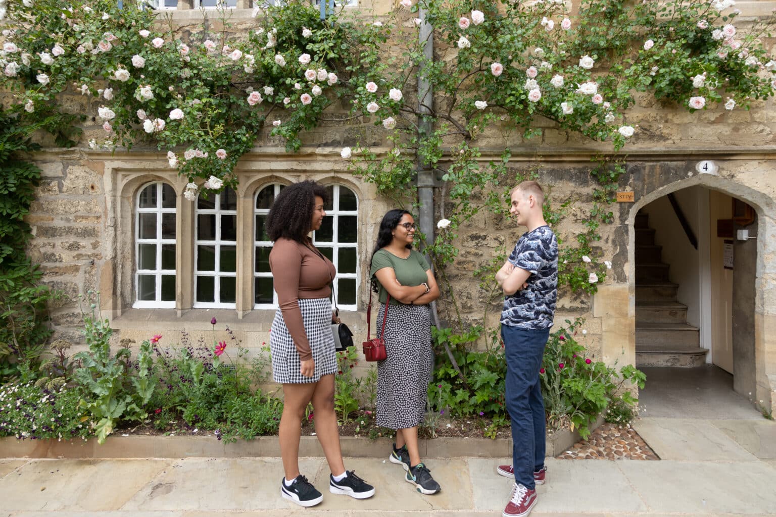 Three students chatting in front quad