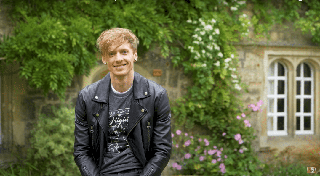 Early Career Teaching and Outreach Fellow, Tom Crawford, better known as Tom Rocks Maths, poses in the Front Quad at St Edmund Hall