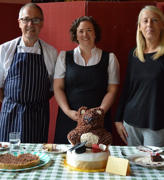 The winning cake in the Teddy Hall Bake Off 2018, with its creator Alex Lloyd and the judges
