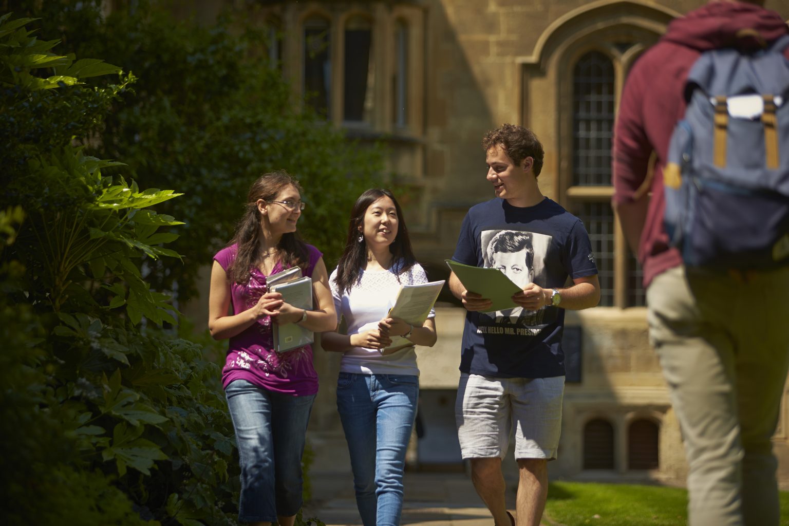 Three students walking through the Front Quad