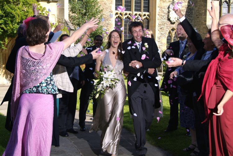 A married couple in the churchyard of St Peter-in-the-East, at St Edmund Hall