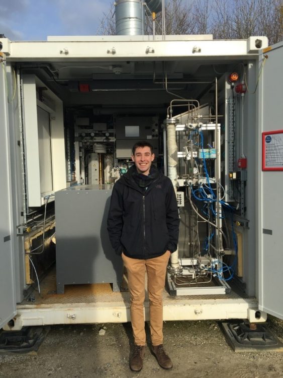 Zac Cesaro (2nd year DPhil in Engineering Science) working at UK Demonstrator, in front of electrolyser and Haber-Bosch synthesis loop.