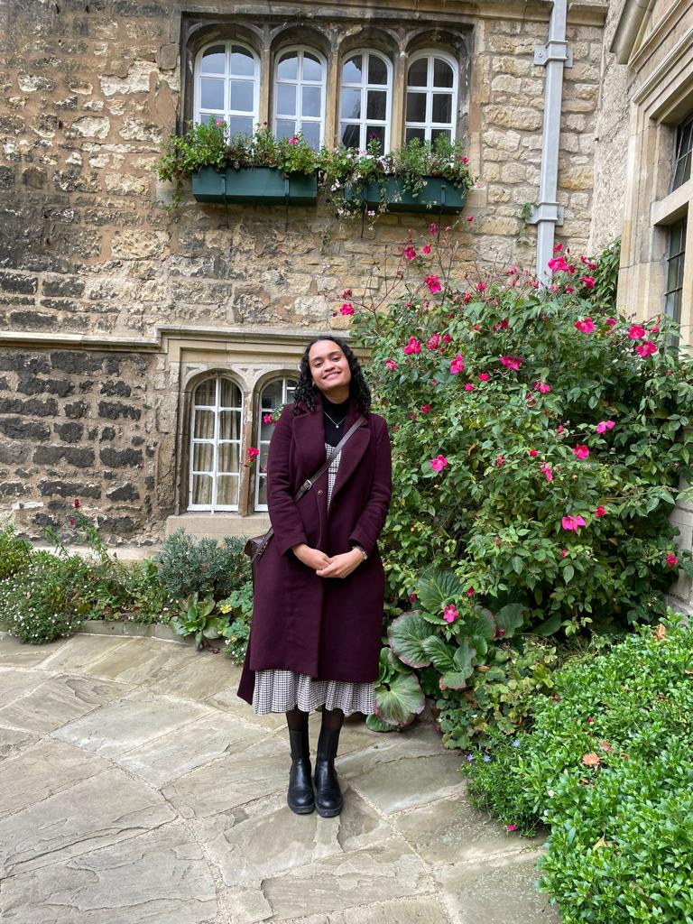 Rebekka stands in the college garden