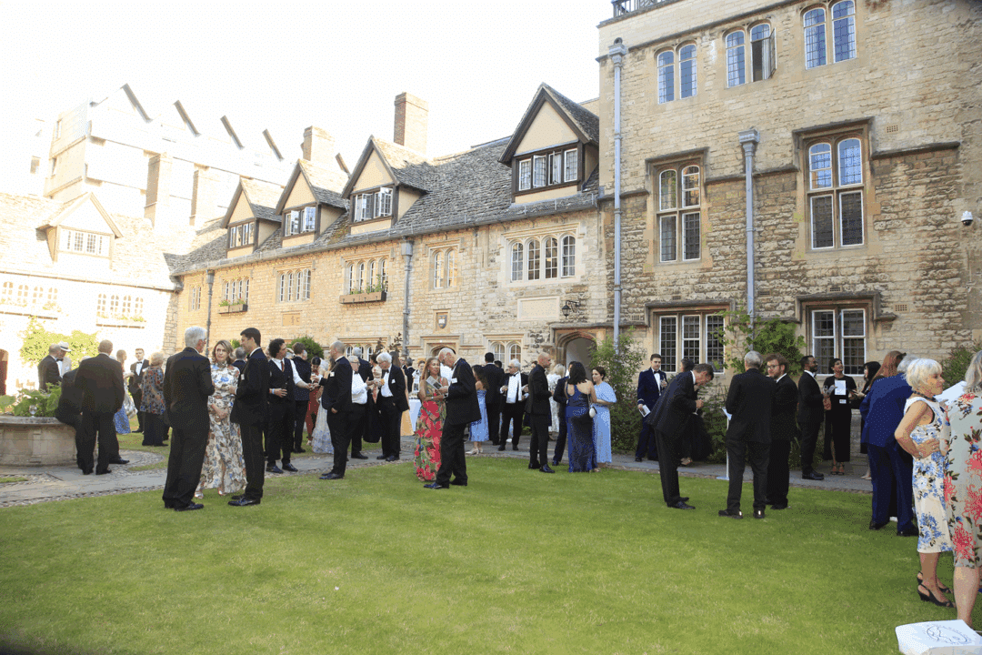 Picture of a large group at the 2025 Alumni Summer Dinner guests in the Front Quad